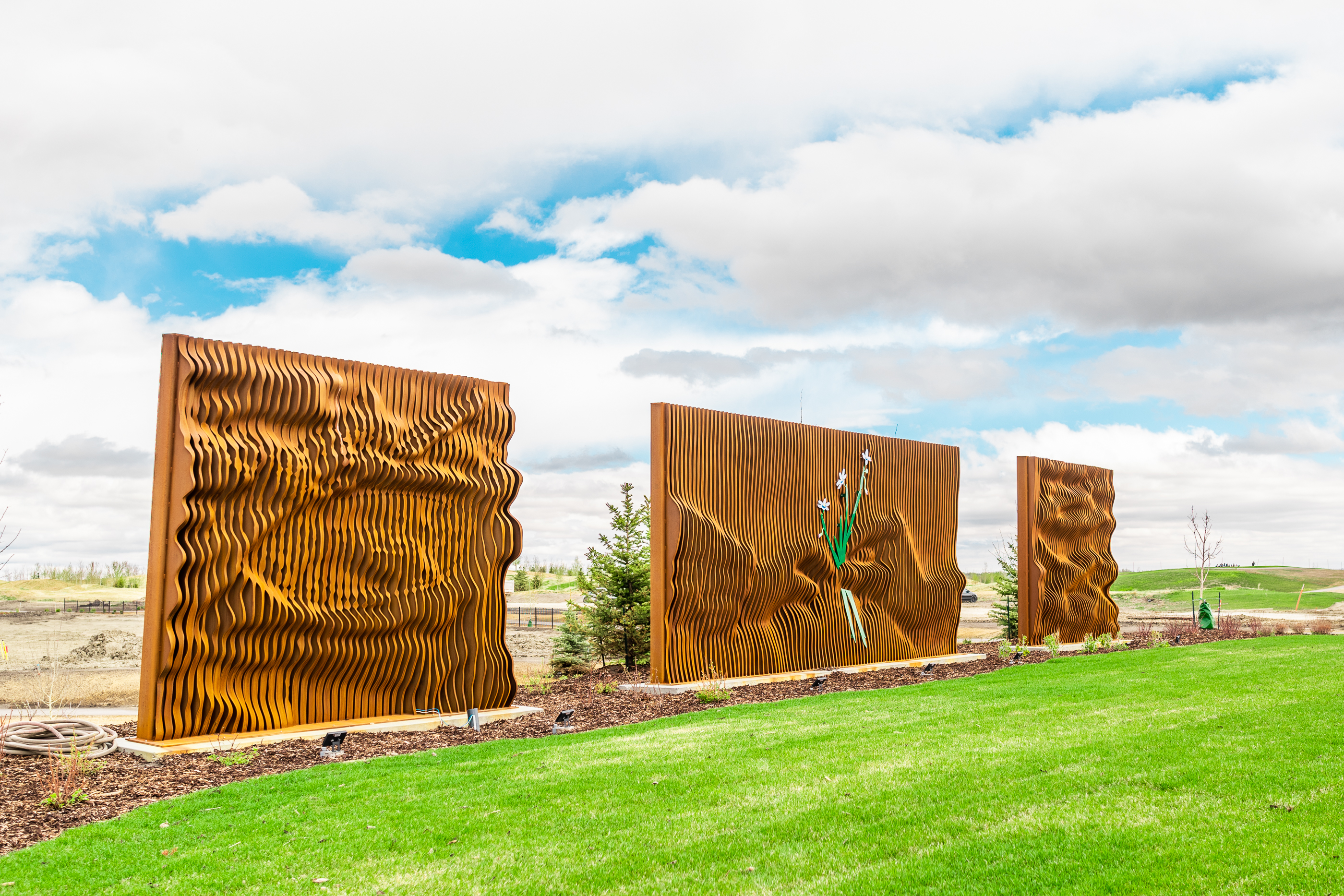 Gordon Skilling’s “[Re]newal - Profound Cycles”. In the centre of the piece, two hands are passing a rare species of grass.