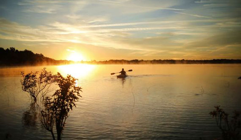 Kayaker at Oak Point during sunset.