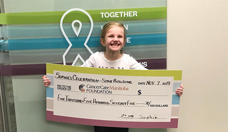 Sophie Presents the Cheque to CancerCare Manitoba