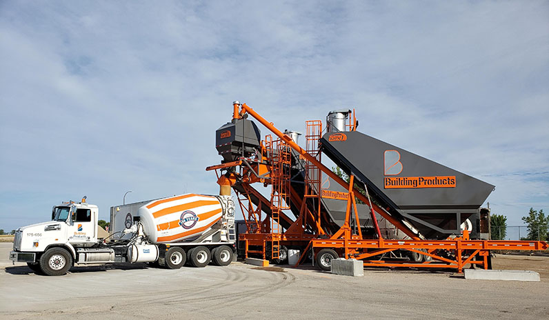Truck Loading up on concrete with the RMX 200, Reliable Mix by Axiom Portable Plant