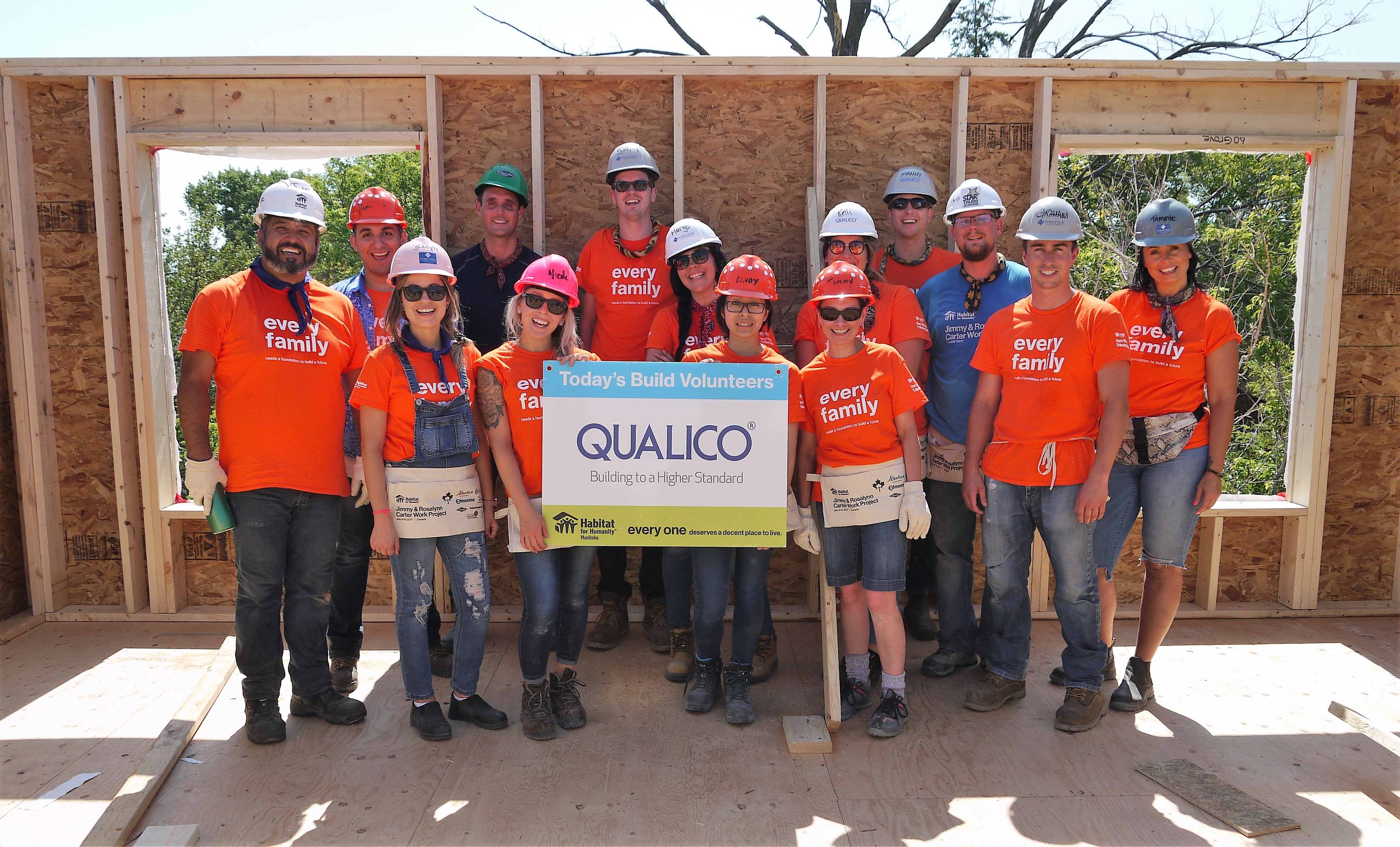 The Qualico Winnipeg Team stands in a new build that they helped put together for the annual volunteer day