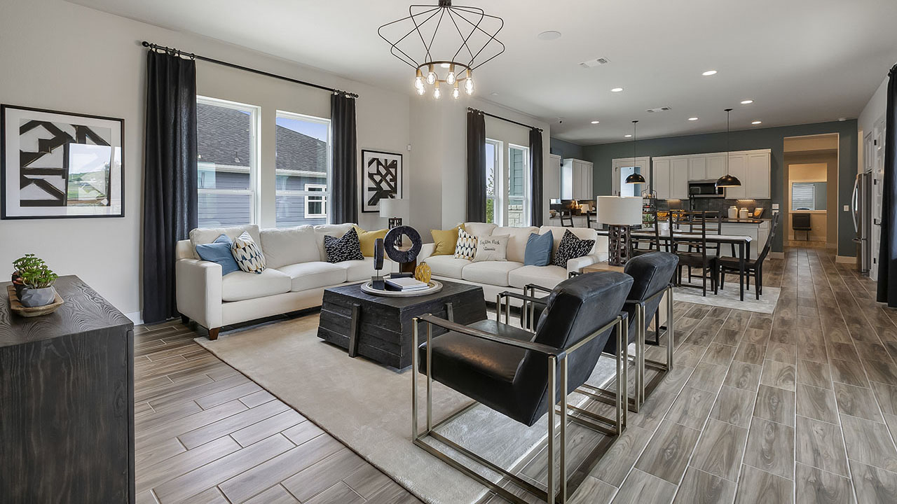 The family room and kitchen of the QUAD model by Pacesetter Homes in Austin.