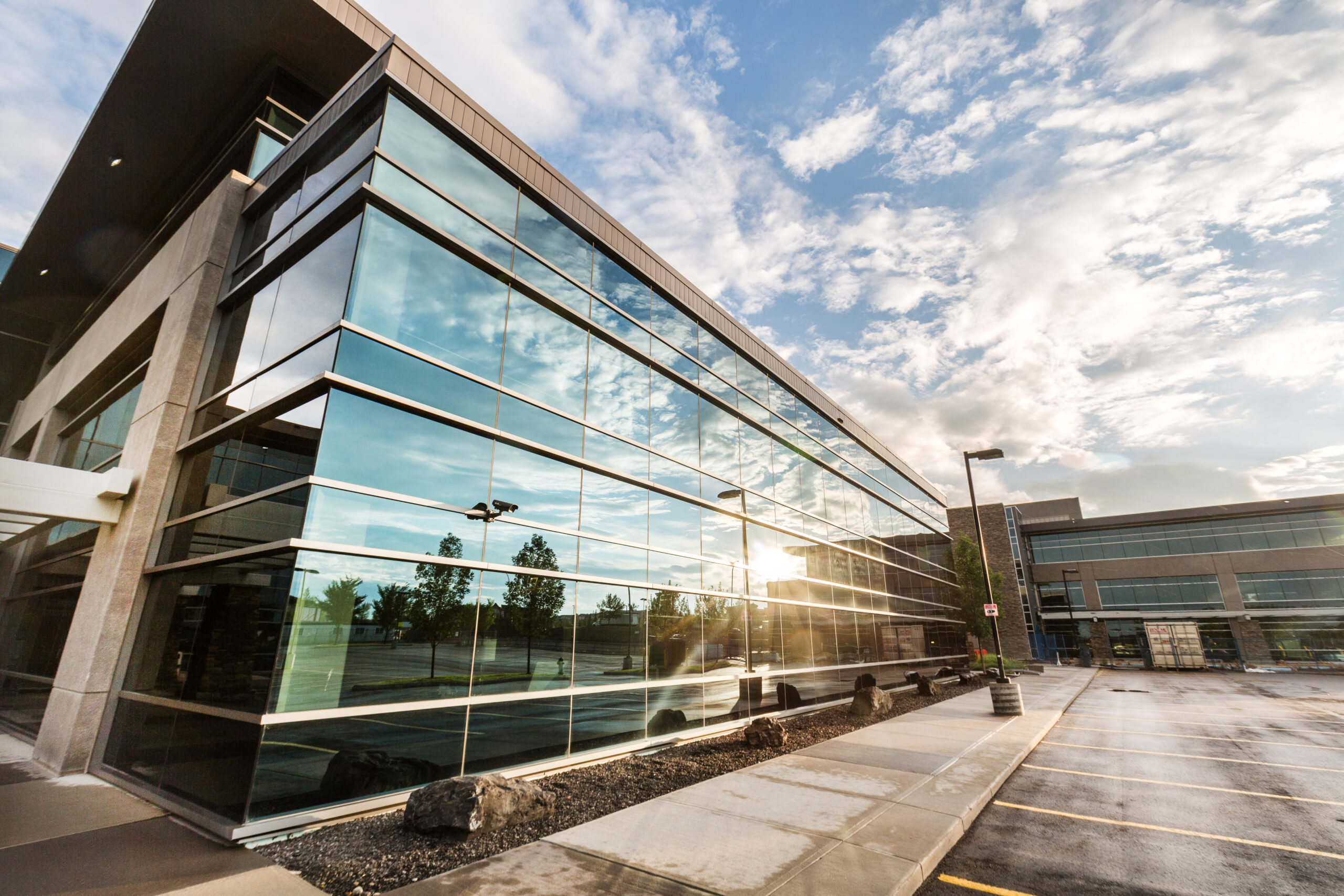 Harvest Hills office building with sun reflecting in the glass façade 