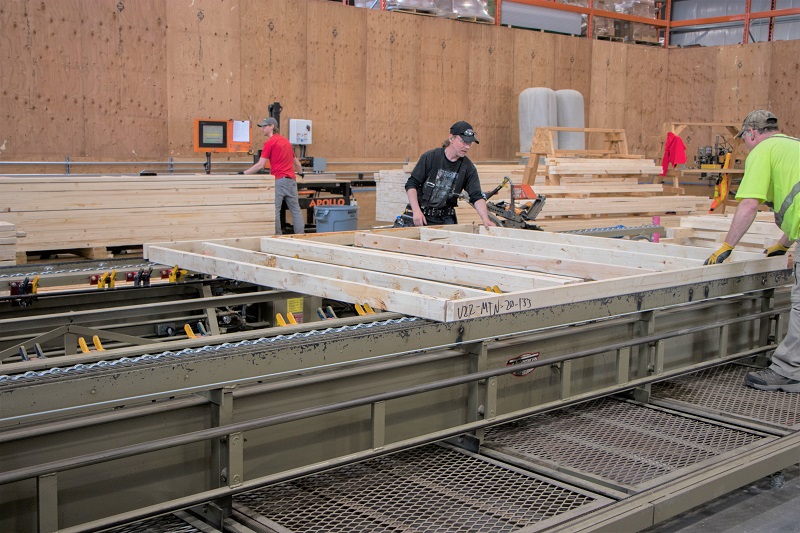 Labourers assembly a wall panel at Star Building Materials Calgary.